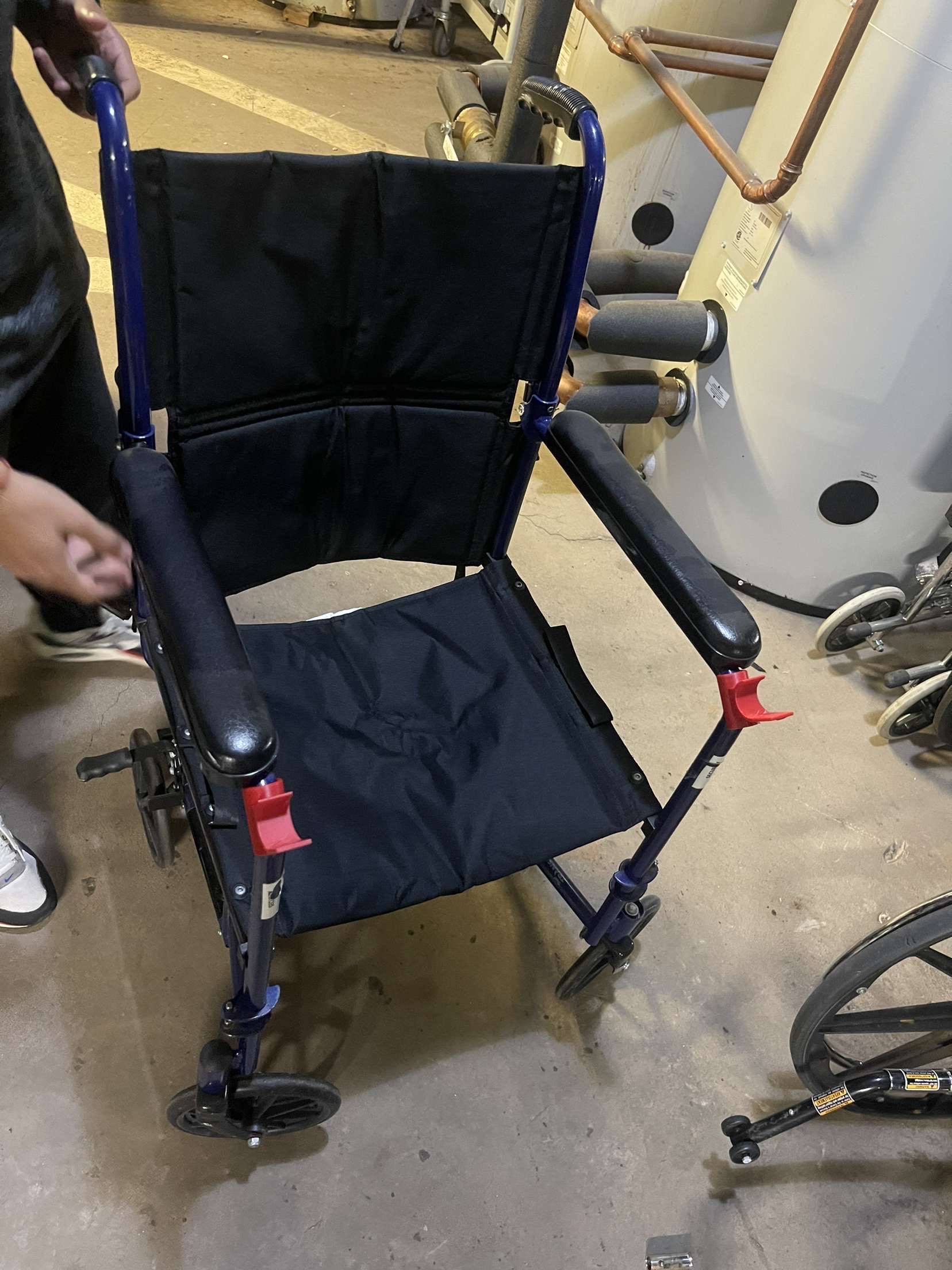 3D-printed cane holder mounted on a transport wheelchair